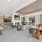  A modern room with a pool table, seating area, and a bar area.