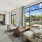 A modern living room with a view of the outdoors through large windows.