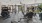  A spacious gym with a variety of equipment and a ceiling fan.