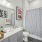  A bathroom with a white sink, toilet, and shower curtain.