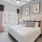  A bedroom with a large bed, a nightstand, and a ceiling fan.