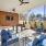  A patio with a table, chairs, and a television.