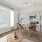  A modern kitchen with a dining table and chairs.