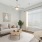  A living room with a couch, a coffee table, and a ceiling fan.